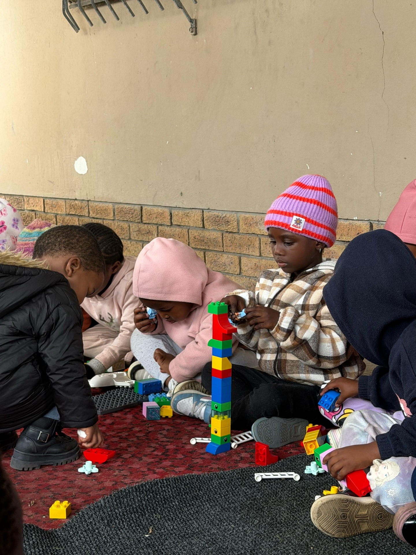 Kids building a tower with colourful blocks